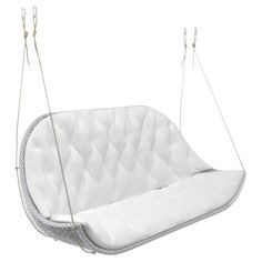 a white swing chair hanging from strings