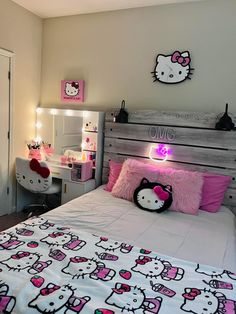 a hello kitty themed bedroom with pink and white accessories on the headboard, bed