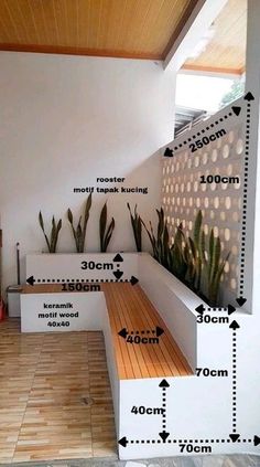 a room with some plants on the wall and wooden flooring in front of it