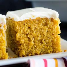 a piece of cake with white frosting on a plate