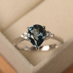 This ring features a 7*9 mm pear cut Genuine London blue topaz . Customization is available. It is made by hand, and it will take about 7 days to finish the ring after your payment is completed. Main stone: 7*9 mm pear cut Genuine London blue topaz Main stone weight: 2.10 ct Metal type: sterling silver /14k gold Accent stone: cz Customization is available, just fee free to contact me, it is free to engrave inside the ring, it is free, you can leave a ntoe with your order, but it will be great no Elegant Pear-shaped Topaz Ring For Gift, Fine Jewelry Pear-shaped Topaz Ring For Anniversary, Pear-shaped Topaz Ring For Anniversary, Fine Jewelry, Fine Jewelry Pear-shaped Topaz Ring, Pear-shaped Topaz Ring For Anniversary, Pear-shaped Topaz Promise Ring, Elegant Sterling Silver Pear-shaped Topaz Ring, Elegant Pear-shaped Topaz Ring In Sterling Silver, Pear-shaped Diamond Topaz Promise Ring