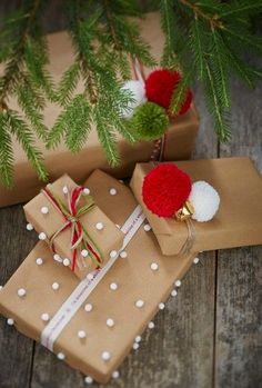 presents wrapped in brown paper with red and white pom - poms on them