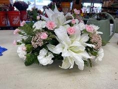 a bouquet of white and pink flowers on a table