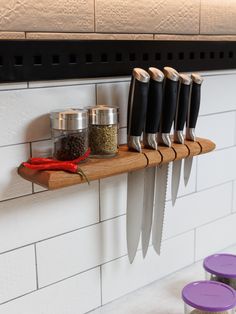 a shelf with knives and spices on it