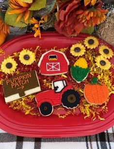 a red plate topped with farm animals and sunflowers