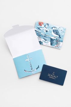 two cards with an anchor and seagull on them, one in blue and the other in white