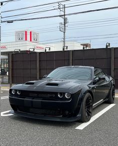 a black sports car parked in a parking lot