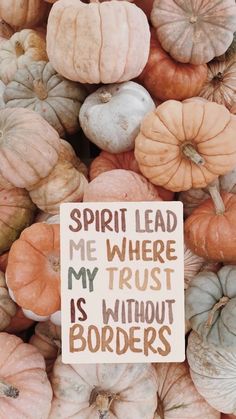 a sign that says spirit lead me where my trust is without borders surrounded by pumpkins