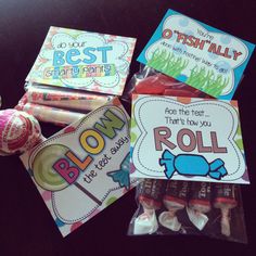 three candy bags with different types of candies in them and some cards on top