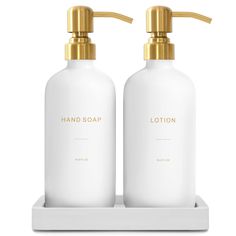 two bottles of lotion on a white tray with gold handles and the words lotion written