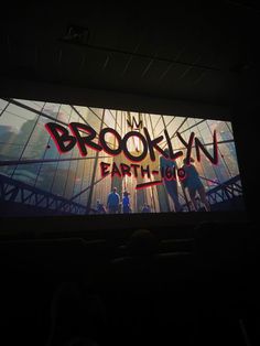 an image of the brooklyn earth tour projected on a large screen in a darkened room