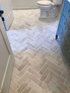 a white toilet sitting next to a bath tub in a bathroom