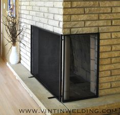 a fireplace with a fire place in the middle and a vase on the other side