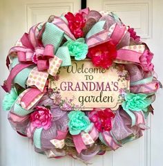 a welcome to grandma's garden wreath hanging on the front door