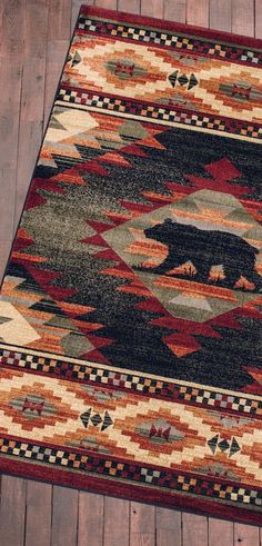 a bear rug is on the floor in front of a wooden floor with wood planks