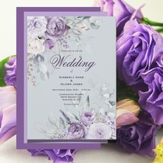 a wedding card with purple flowers and greenery