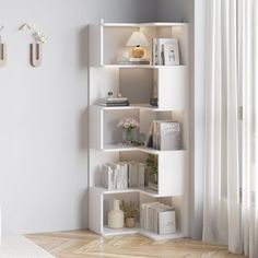 a white book shelf in the corner of a room