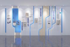 an empty room with blue and white wallpaper, phone booths and signs on the walls