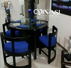 a glass table with blue chairs around it