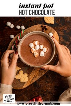 hot chocolate with marshmallows in a bowl on a wooden platter and text overlay that reads instant pot hot chocolate