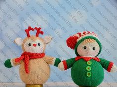 two knitted christmas dolls standing next to each other