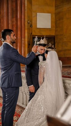 a bride and groom are getting ready to walk down the aisle