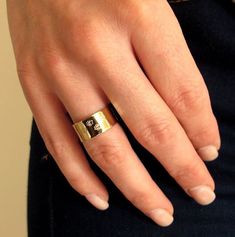 a woman's hand with a gold ring on it