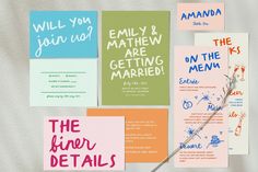 the wedding stationery is laid out on top of each other, including cards and pins