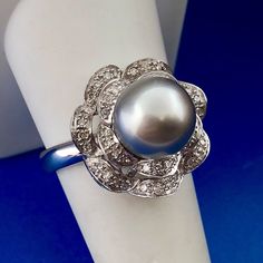 * Designer 14K White Gold Tahitian Pearl Diamond Statement Cocktail Ring * Ring size: 9 * Top of ring measures: 3/4" diameter * Band width: 1/8" * Tahitian Pearl measures: approximately 10 mm * 50 accent diamonds measure: approximately .80 mm each * Weight: 7.3 tgw * Marked: 14K RJS * Condition: Great * Ring can be sized for an additional fee * (G275)    Exported By ExportYourStore :) Luxury Tahitian Pearl Jewelry For Anniversary, Luxury Tahitian Pearl Anniversary Jewelry, White Gold Tahitian Pearl Jewelry For Anniversary, Classic Silver Ring With Tahitian Pearl, Classic White Gold Tahitian Pearl Rings, Classic Silver Tahitian Pearl Ring, Luxury Silver Tahitian Pearl Ring, Luxury Tahitian Pearl Ring For Formal Occasions, Silver Tahitian Pearl Ring In Fine Jewelry Style