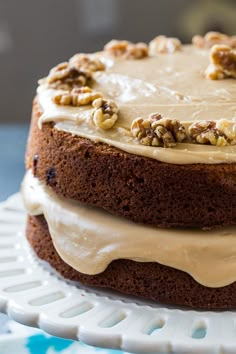 a cake with frosting and walnuts on top