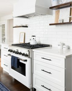 a stove top oven sitting inside of a kitchen