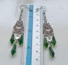 Green crystal spike long dangle earrings with rubber backs. Length from end to end: 9cm, 3.5" Earring hook material: 316 l stainless steel Crystal color: green Crystal spike size: 16 x 6mm This listing is for the crystal spike earrings shown in the pictures. These earrings will come in a gift bag. I offer combined shipping costs which give you a shipping discount for ordering multiple items from my shop. See more chain/cord/wire click here: http://etsy.me/2qSGJ6b Don't forget to purchase the matching set of bails, clasps, necklace/bracelet connectors click here:  http://etsy.me/2re5rjD ...and check out some of charms & pendants listings: http://etsy.me/2rbfw0M or visit my shop looking for more jewelry findings: https://www.etsy.com/shop/TikisCraftShop Estimated delivery times (after packag Green Chandelier Pierced Earrings For Party, Green Chandelier Earrings For Party, Green Crystal Earrings For Jewelry Making, Green Pierced Chandelier Earrings For Party, Green Crystal Pierced Earrings For Party, Elegant Green Crystal Dangle Earrings, Green Crystal Dangle Earrings, Green Dangle Crystal Earrings For Gift, Green Dangle Crystal Earrings