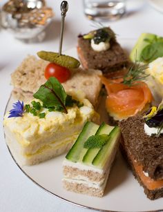 a white plate topped with lots of different types of food on top of a table