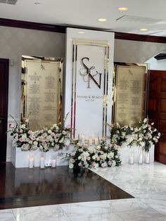 flowers and candles are placed in front of the wall