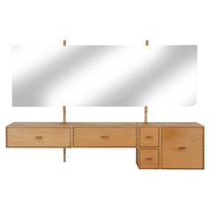 a wooden dresser with two mirrors on it and one drawer open to reveal a large mirror