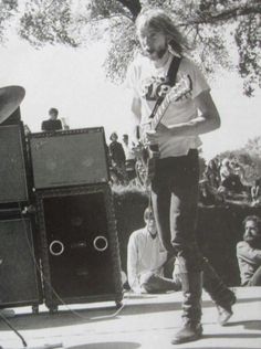 a man standing on top of a stage with an electric guitar