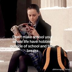 a woman sitting on the steps reading a book