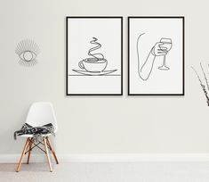 two black and white paintings hang on the wall next to a chair