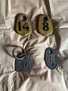 three old metal numbers are laying on a piece of paper