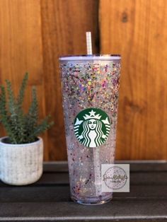 a starbucks cup with sprinkles and a straw