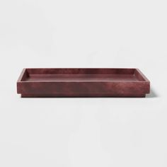 a wooden tray on a white surface with no one in the photo or description to describe