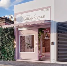 a store front with pink and white decor