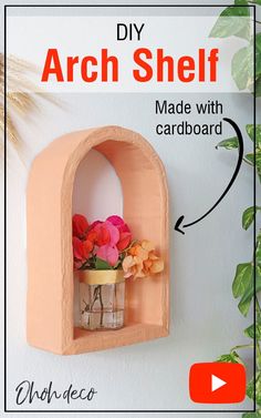 the diy arch shelf is made with cardboard and decorated with flowers in a vase