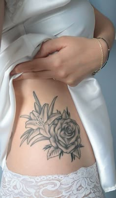 a woman with a flower tattoo on her stomach