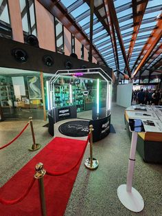 a red carpeted area with an exhibit in the middle