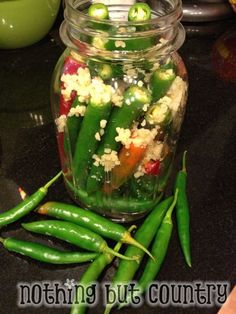 green beans and other vegetables in a glass jar on a counter top with the words nothing but country