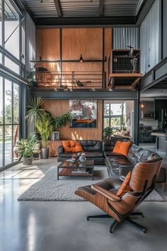 a living room filled with lots of furniture next to tall glass windows on the wall