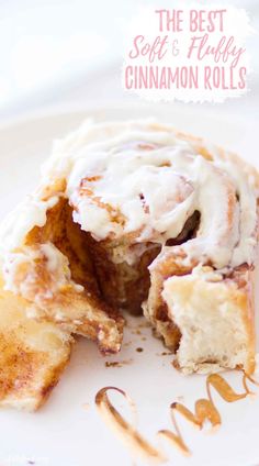 cinnamon roll with icing on a white plate next to the words, the best soft & fluffy cinnamon rolls