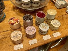 there are many different desserts on the table with name tags around them and labels for each individual item