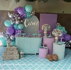 a table topped with balloons and other decorations